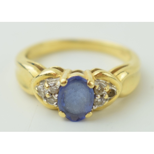 528 - 18ct yellow gold dress ring, set diamond shoulders. central stone believed tanzanite. Ring size 'M /... 