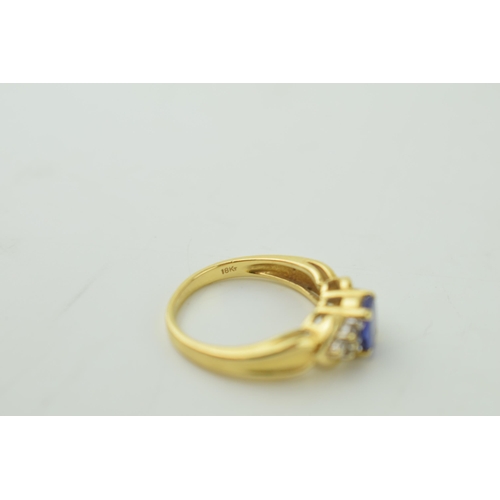 528 - 18ct yellow gold dress ring, set diamond shoulders. central stone believed tanzanite. Ring size 'M /... 