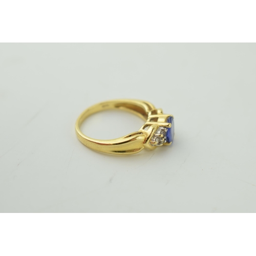 528 - 18ct yellow gold dress ring, set diamond shoulders. central stone believed tanzanite. Ring size 'M /... 