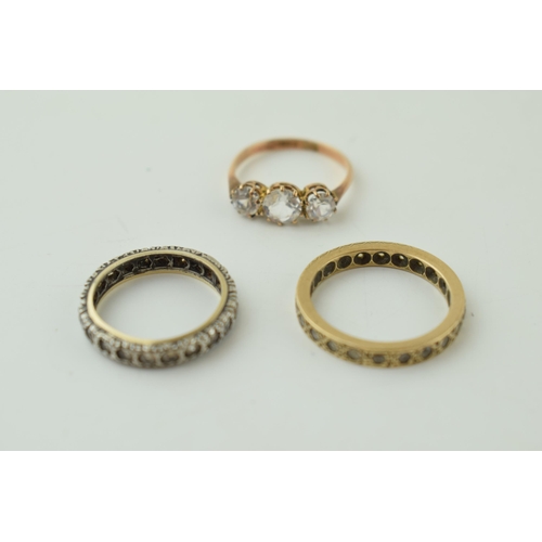 544 - A pair of 9ct gold rings, stone set, one eternity, 4.6g, with a silver and gold eternity ring (3).