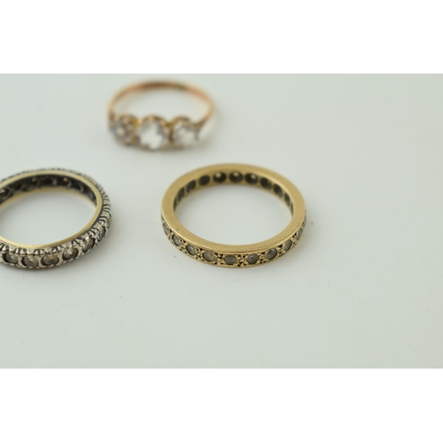 544 - A pair of 9ct gold rings, stone set, one eternity, 4.6g, with a silver and gold eternity ring (3).