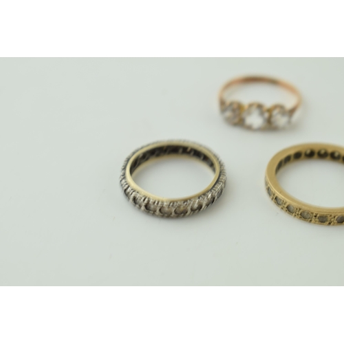 544 - A pair of 9ct gold rings, stone set, one eternity, 4.6g, with a silver and gold eternity ring (3).