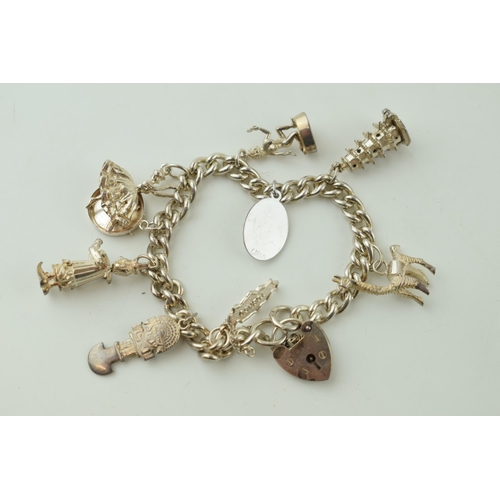 547 - Silver charm bracelet, 47.4g, to include a jester, a llama, a temple and others.