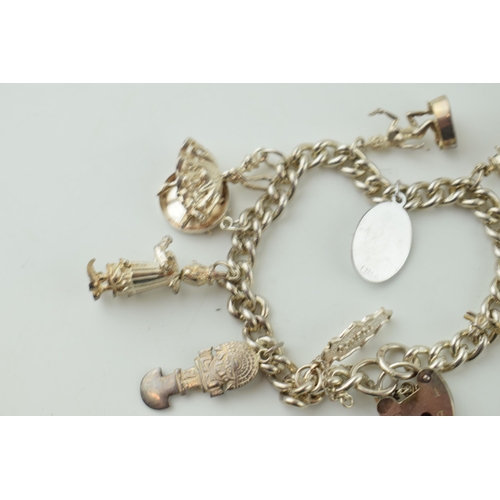 547 - Silver charm bracelet, 47.4g, to include a jester, a llama, a temple and others.