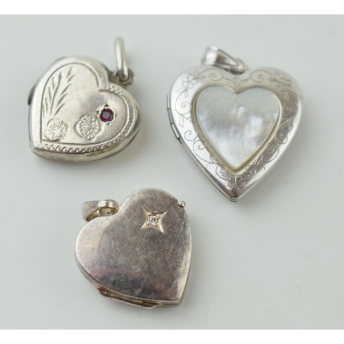 551 - Three silver front and back heart shape lockets, all stone set.