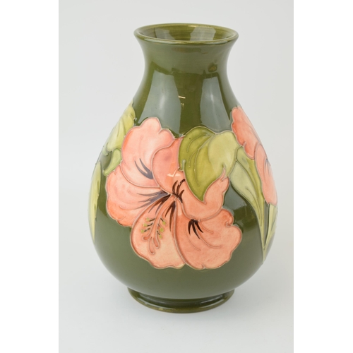 204 - Moorcroft bulbous vase in the Hibiscus pattern, on green, 20.5cm tall.