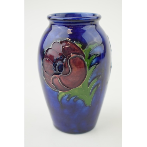 207 - Moocroft Hibiscus on blue vase, 10.5cm tall.