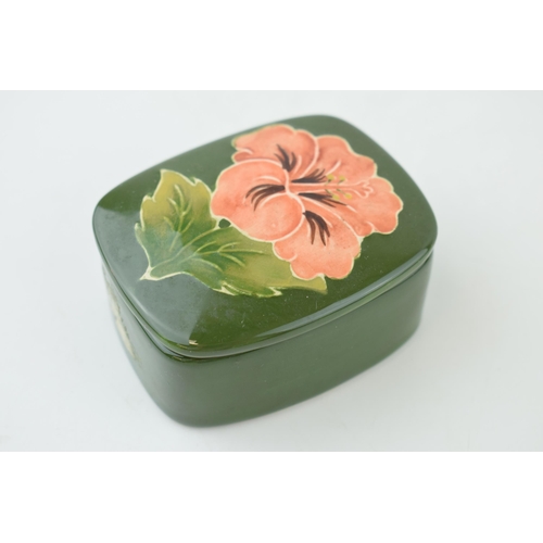 210 - Moorcroft hibiscus on green trinket dish, 7.5cm wide.