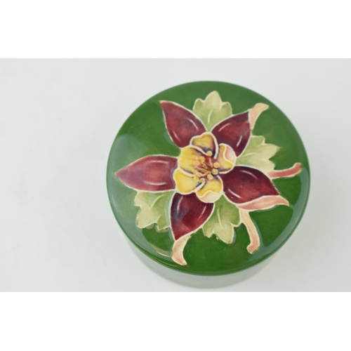 216 - Moorcroft circular trinket dish with floral design, 6.5cm diameter.