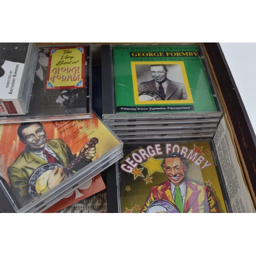 45 - A collection of George Formby music on cassette and CD together with a 'Dick Whittington' Manchester... 