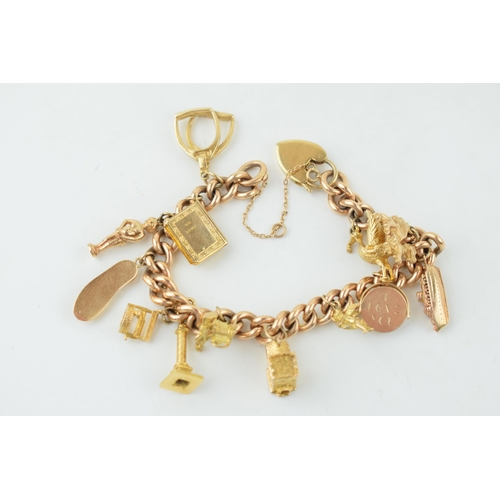 548 - A yellow gold charm bracelet. 15ct gold Victorian Albert chain with 14 individual 9ct yellow gold vi... 