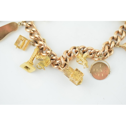 548 - A yellow gold charm bracelet. 15ct gold Victorian Albert chain with 14 individual 9ct yellow gold vi... 