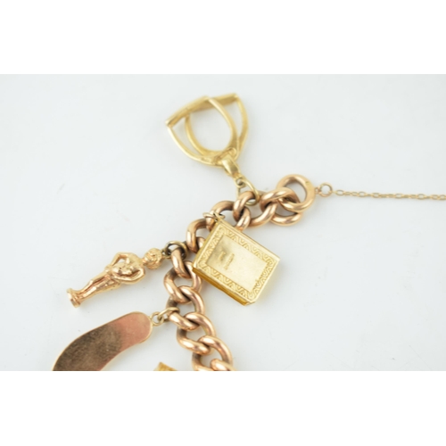 548 - A yellow gold charm bracelet. 15ct gold Victorian Albert chain with 14 individual 9ct yellow gold vi... 