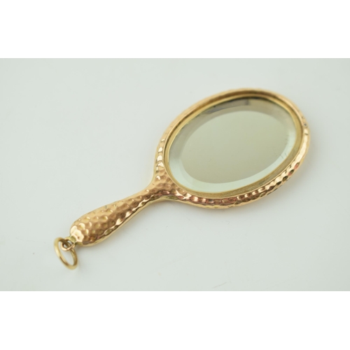 560 - A 9ct yellow gold miniature novelty mirror with chain loop. 8cm x 3.5cm. Gross weight 11.1 grams.