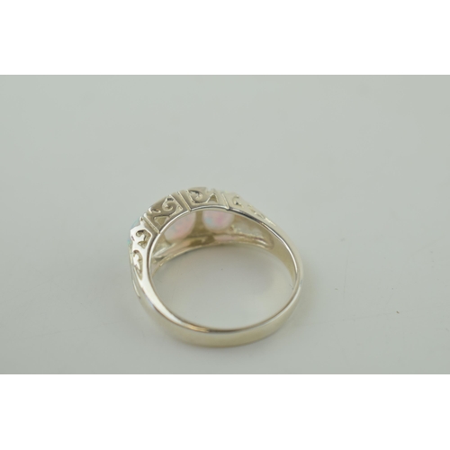 575 - A sterling silver contemporary ring set with Opal style stones. Ring size 'O'.