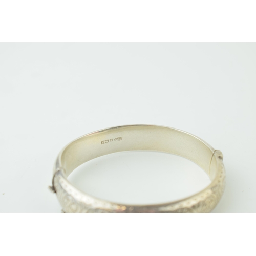 582 - Two silver engraved bangles / bracelets, working clasps, engraved floral decoration, 45g (2).