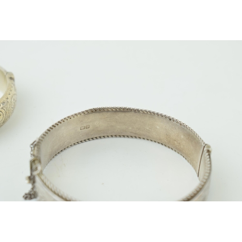 582 - Two silver engraved bangles / bracelets, working clasps, engraved floral decoration, 45g (2).