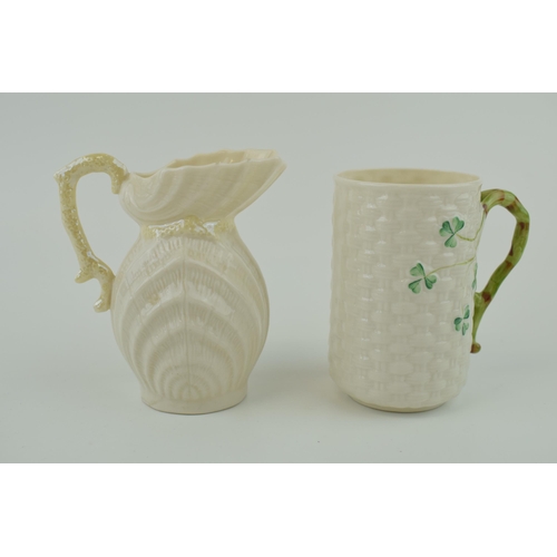 102 - A Belleek shell ribbed jug with ornate handle (chip to handle) with a wicker effect cup (2), tallest... 