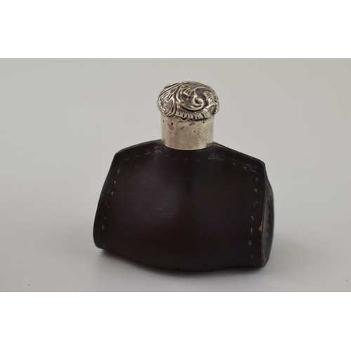 109 - Doulton Lambeth leather ware scent bottle in the form of a purse, silver screw top lid, 4.5cm wide.