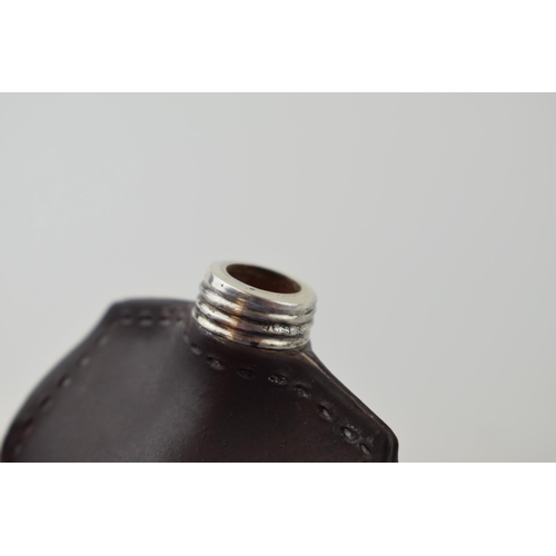 109 - Doulton Lambeth leather ware scent bottle in the form of a purse, silver screw top lid, 4.5cm wide.