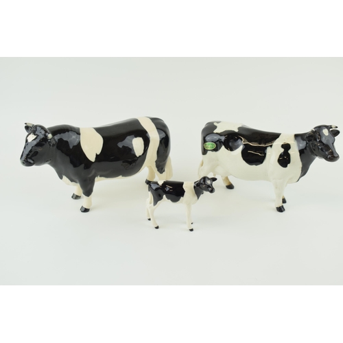 23 - Beswick cattle family to include a Friesian Bull, a Friesian Cow and a Friesian Calf (3).