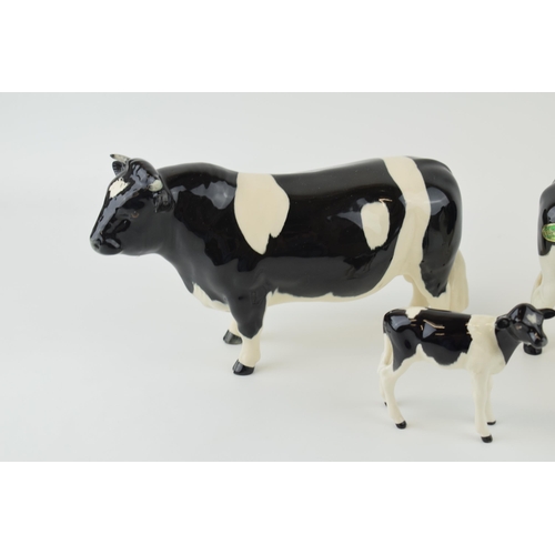 23 - Beswick cattle family to include a Friesian Bull, a Friesian Cow and a Friesian Calf (3).