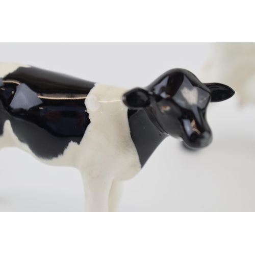 23 - Beswick cattle family to include a Friesian Bull, a Friesian Cow and a Friesian Calf (3).