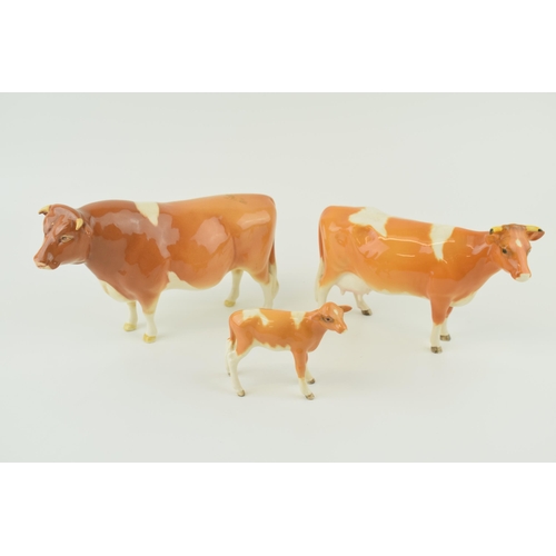 24 - Beswick cattle family to include the Guernsey Bull, Guernsey Cow and Guernsey Calf (3).