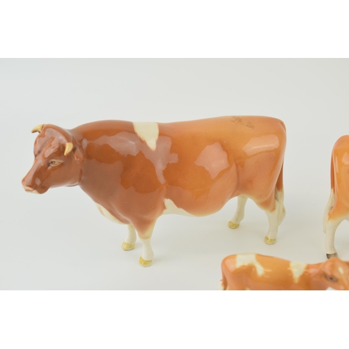 24 - Beswick cattle family to include the Guernsey Bull, Guernsey Cow and Guernsey Calf (3).