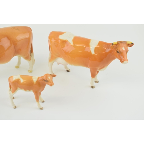 24 - Beswick cattle family to include the Guernsey Bull, Guernsey Cow and Guernsey Calf (3).