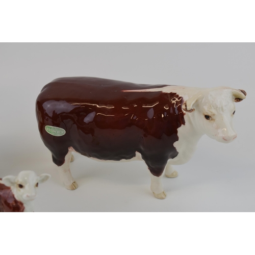 25 - Beswick cattle family to include the Hereford Bull, Hereford Cow and Hereford Calf (3).