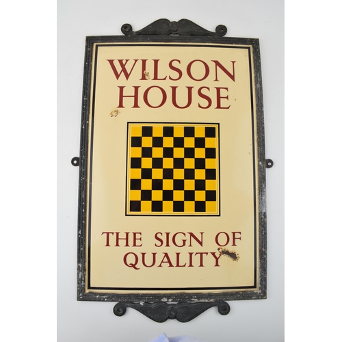 Enamel Brewery Sign 'WILSON HOUSE' 'THE SIGN OF QUALITY', Cream ground with maroon script. Black and Yellow chequerboard to centre. 'Wilson's Brewery Ltd' Newton Heath Brewery, Manchester. In original cast metal frame. 31cm x 52cm.