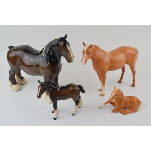 37 - Beswick to include a brown 818 shire horse, a large shire foal 953 (damaged ears), a palomino 915 an... 