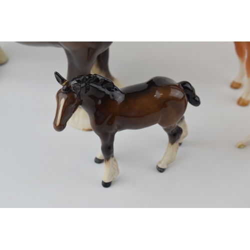 37 - Beswick to include a brown 818 shire horse, a large shire foal 953 (damaged ears), a palomino 915 an... 