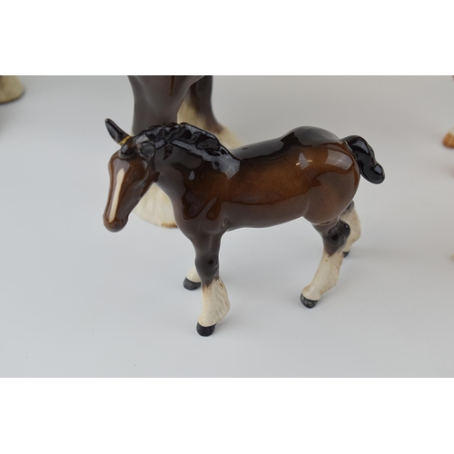 37 - Beswick to include a brown 818 shire horse, a large shire foal 953 (damaged ears), a palomino 915 an... 