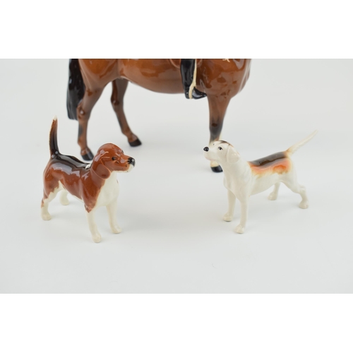 5 - Beswick Huntsman together with a beagle and a foxhound. (3) Height 21cm.