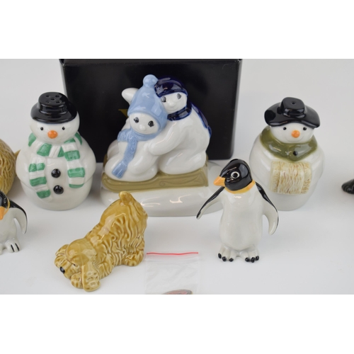 52 - A collection of Wade novelty figures to include boxed pair of Penguins Cats and Dogs Snowmen cruet s... 