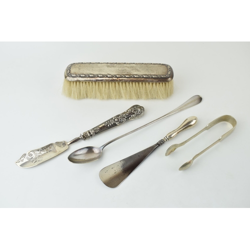 525 - A collection of silver and silver-plated items to include a silver brush, silver handled shoe horn, ... 