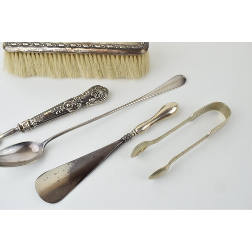 525 - A collection of silver and silver-plated items to include a silver brush, silver handled shoe horn, ... 