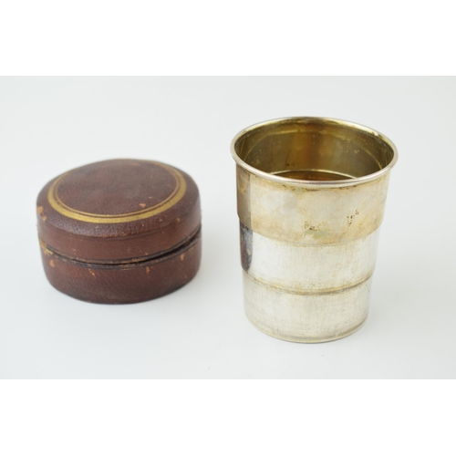 531 - A silver plated collapsible cup, probably for hunting, gilt wash interior, with leather circular cas... 