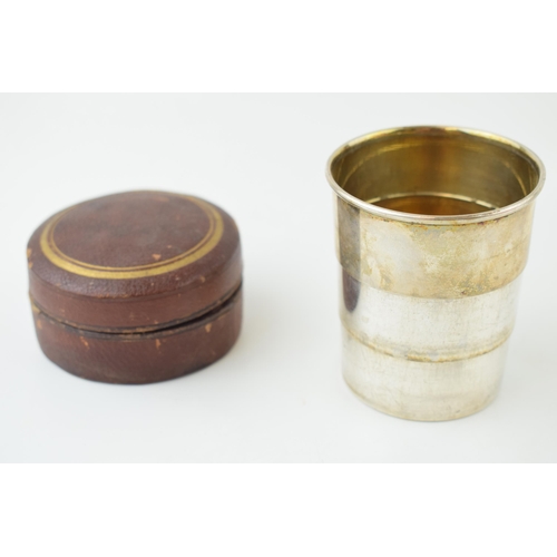 531 - A silver plated collapsible cup, probably for hunting, gilt wash interior, with leather circular cas... 