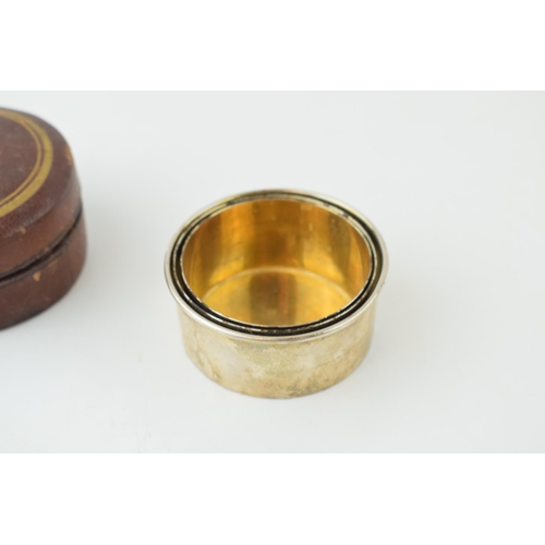 531 - A silver plated collapsible cup, probably for hunting, gilt wash interior, with leather circular cas... 