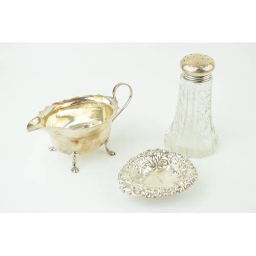 536 - Silver to include a silver topped sugar shaker, Birm 1914/1939, a sauce dish Birm 1929 and a sweet d... 