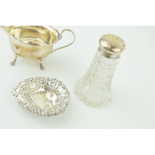 536 - Silver to include a silver topped sugar shaker, Birm 1914/1939, a sauce dish Birm 1929 and a sweet d... 