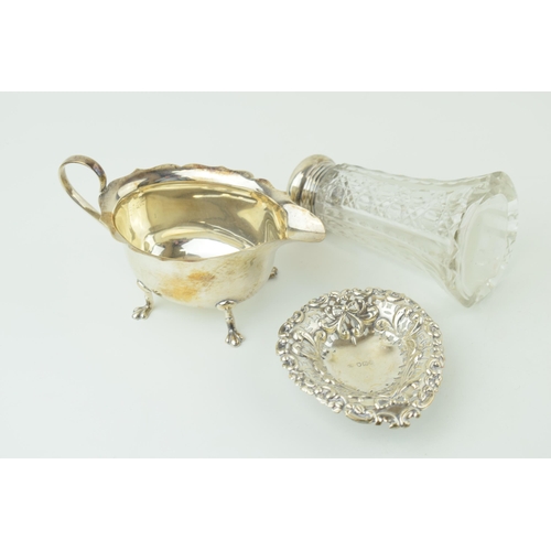 536 - Silver to include a silver topped sugar shaker, Birm 1914/1939, a sauce dish Birm 1929 and a sweet d... 