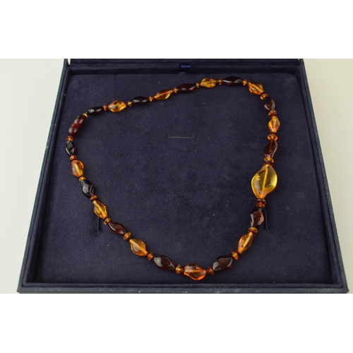 543 - Amber necklace, graduated size and colours, 10.0g, in presentation box, 43cm long.