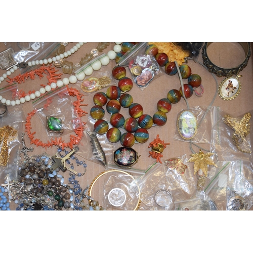 592 - A collection of costume jewellery to include a medal, bangles, a multicoloured glass necklace, rings... 