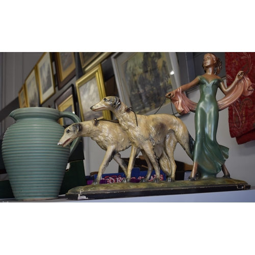 82 - An Art Deco figure of lady holding two Saluki type dogs together with an Art Deco jug by Lovatts. He... 