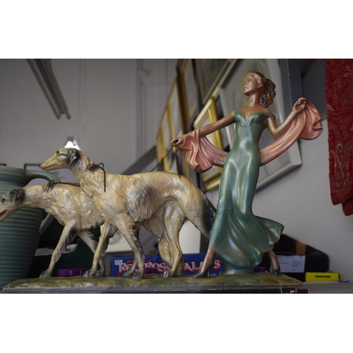 82 - An Art Deco figure of lady holding two Saluki type dogs together with an Art Deco jug by Lovatts. He... 