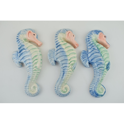 87 - A trio of Devon Ceramics Ltd wall plaques in the form of sea horses, 17.5cm tall (3).